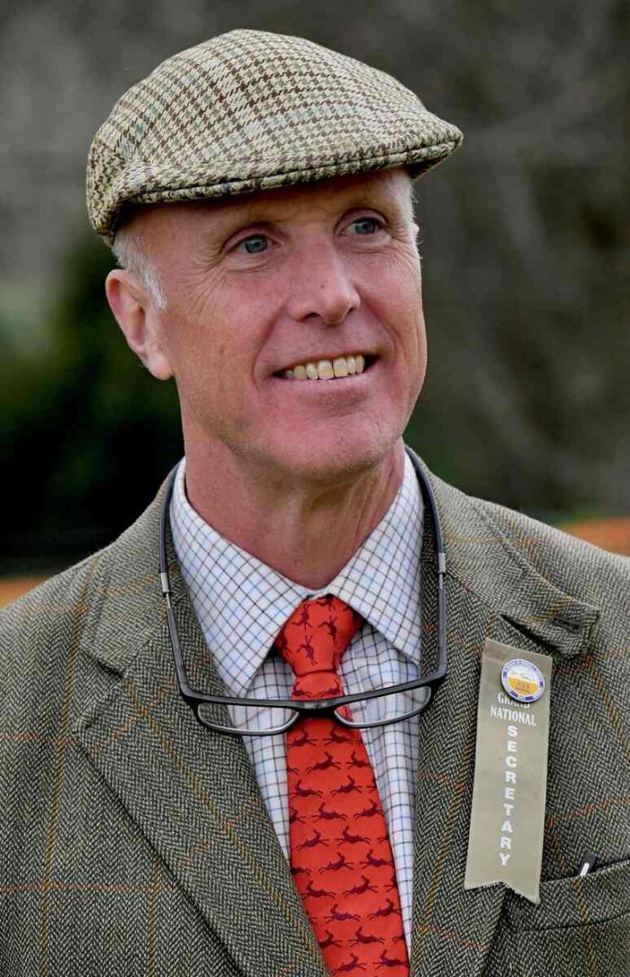 Man with tweed cap, ribbon on lapel of tweed jacket